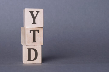 A wooden block arrangement forming the acronym YTD, representing year-to-date financial performance...