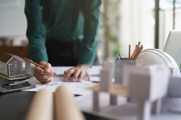 Interior architect working with blueprint planning in modern office, engineering concept
