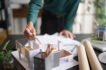 Interior architect or engineer working on blueprint at office