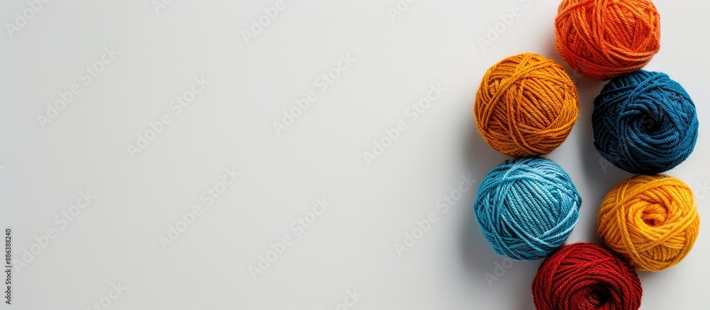 Poster four yarn balls for knitting positioned on a white backdrop, offering a blank space in the image for