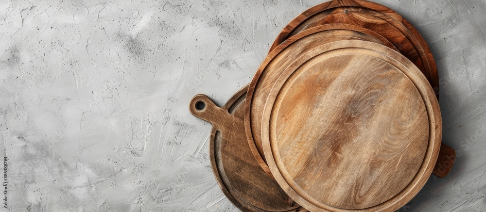 Poster top view of round cutting boards on a grey background with copy space image for text or design.