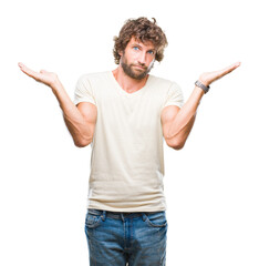 Handsome hispanic model man over isolated background clueless and confused expression with arms and...