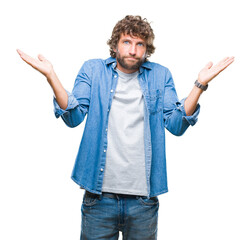 Handsome hispanic model man over isolated background clueless and confused expression with arms and...