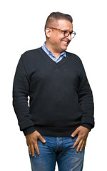 Fototapeta premium Middle age bussines arab man wearing glasses over isolated background looking away to side with smile on face, natural expression. Laughing confident.
