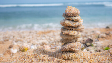 small coral rocks piled up on a white sandy beach