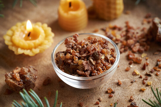 Myrrh resin with candles made of beeswax. Christmas incense for aromatherapy or alternative medicine.
