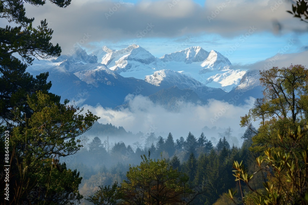 Poster a mountain range with snow-covered peaks visible in the background under a foggy sky, distant snow-c