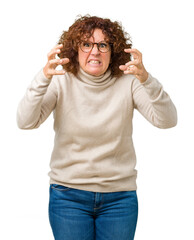 Fototapeta premium Beautiful middle ager senior woman wearing turtleneck sweater and glasses over isolated background Shouting frustrated with rage, hands trying to strangle, yelling mad