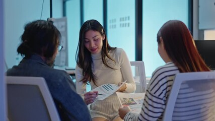 group of Happy young asian business people chatting happily after a night of overtime work in the office.Supervisor chats with employees after working together planning success strategy enjoy teamwork - Powered by Adobe
