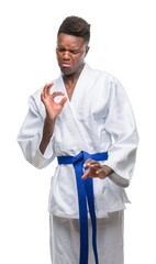 Young african american man over isolated background wearing kimono disgusted expression, displeased and fearful doing disgust face because aversion reaction. With hands raised. Annoying concept.