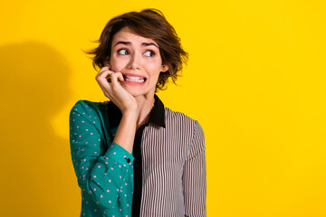 Photo of worried nervous lovely girl wear stylish striped clothes bite nails empty space isolated...