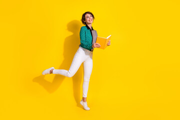 Fototapeta na wymiar Full length photo of charming adorable woman wear trendy clothes look empty space isolated on yellow color background