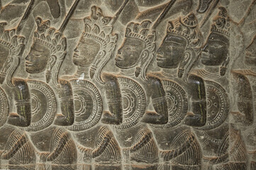 Carved bas relief of ancient warriors at Angkor Wat temple, Siem Reap, Cambodia.