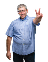 Naklejka premium Handsome senior man wearing glasses over isolated background smiling with happy face winking at the camera doing victory sign. Number two.