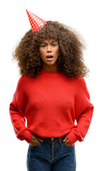 African american woman celebrates birthday scared in shock with a surprise face, afraid and excited with fear expression