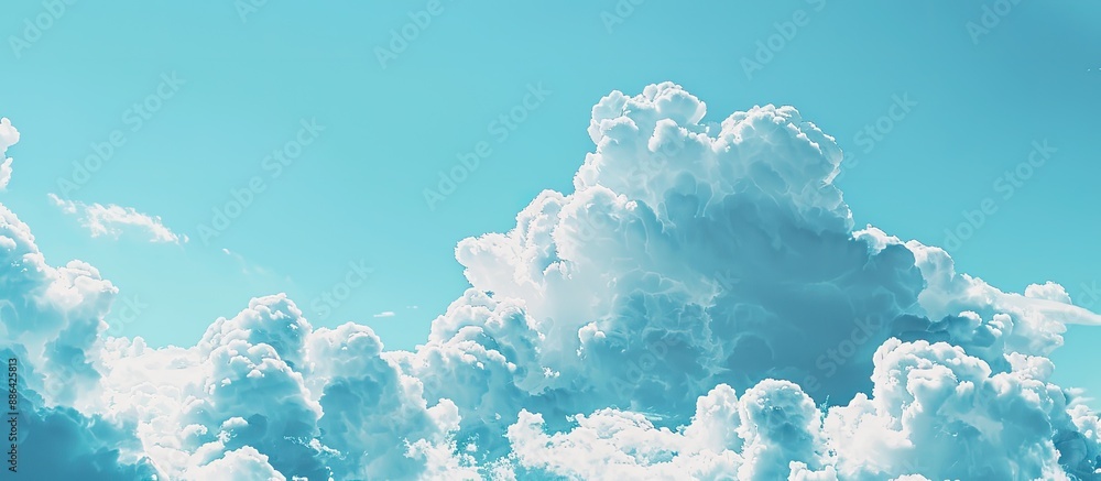 Poster fluffy clouds drifting in the blue sky provide a serene copy space image
