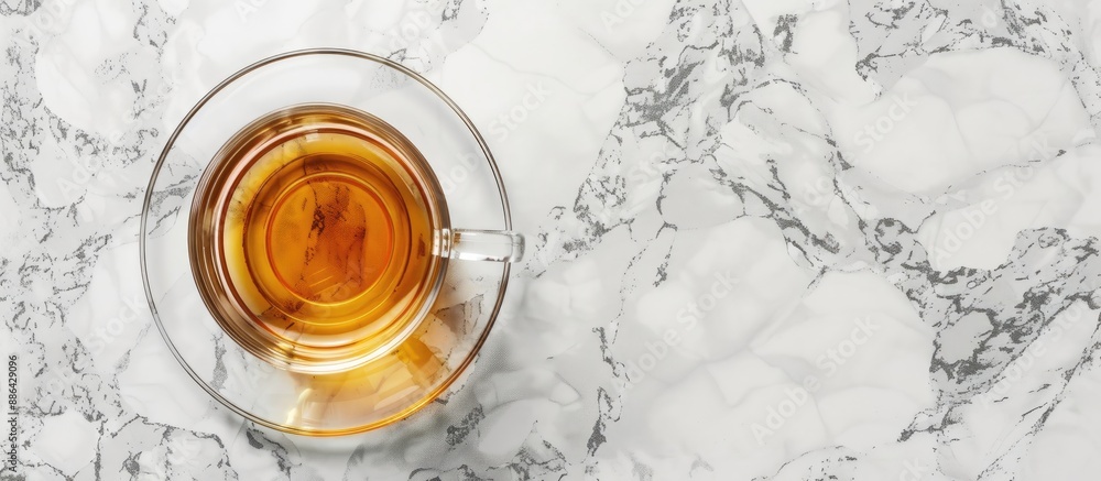 Poster top view of a transparent glass mug with saucer on a marble surface perfect for showcasing with avai