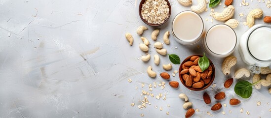 Assorted vegan almond and cashew milk displayed on a table with a top view featuring a copy space image