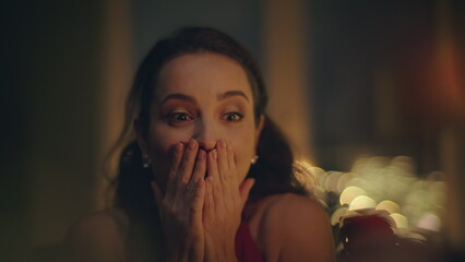 Excited woman reacting engagement ring at romantic atmosphere house closeup