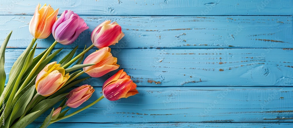 Aufkleber tulip bouquet displayed on a blue wooden table for women s day and mother s day set up as a flat lay
