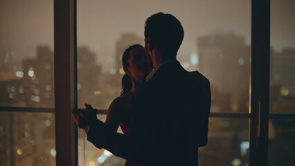 Silhouettes couple dancing date evening cityscape kitchen closeup. Spouses dance