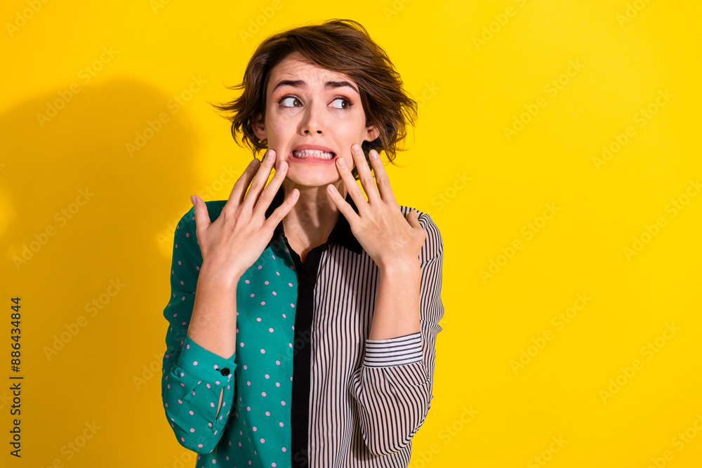 Wall mural photo of anxious embarrassed girl wear stylish print clothes look empty space isolated on yellow col