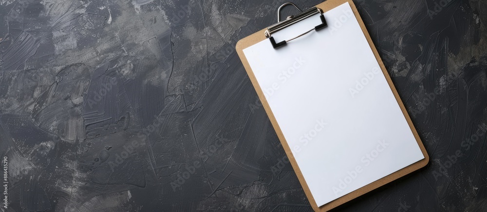 Aufkleber close up of clipboard with blank paper on dark gray background copy space image