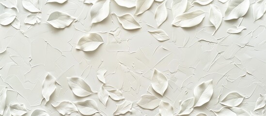 A white backdrop adorned with textured leaf patterns creating a charming copy space image