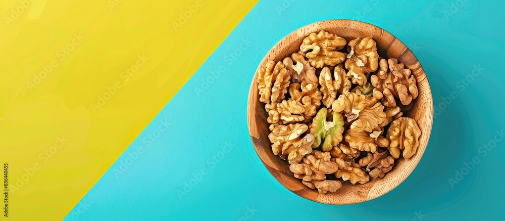 Poster close up from above of walnut kernel halves in a wooden bowl on a colored background depicting a hea