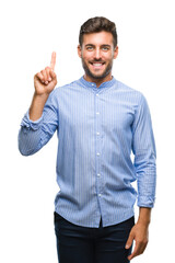 Young handsome man over isolated background showing and pointing up with finger number one while smiling confident and happy.