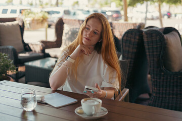 Woman in cafe with a smartphone