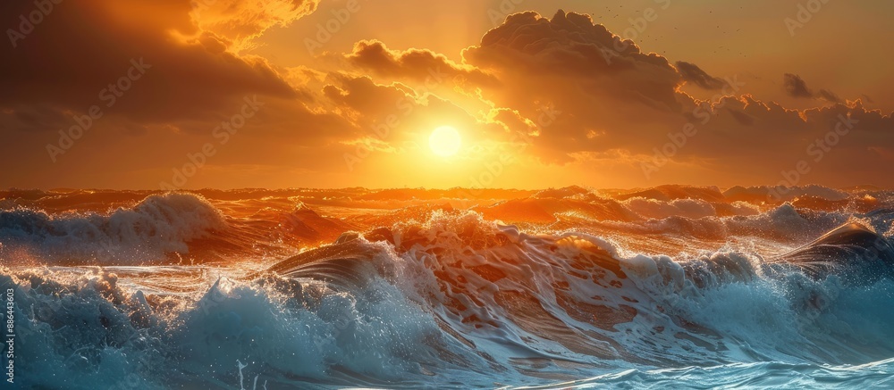 Poster scenic sunset over the sea with the yellow sun casting its light on the big storm waves creating a b