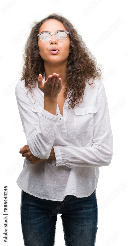 Poster Beautiful young hispanic woman looking at the camera blowing a kiss with hand on air being lovely and sexy. Love expression.