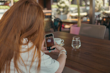 Woman in cafe with a smartphone
