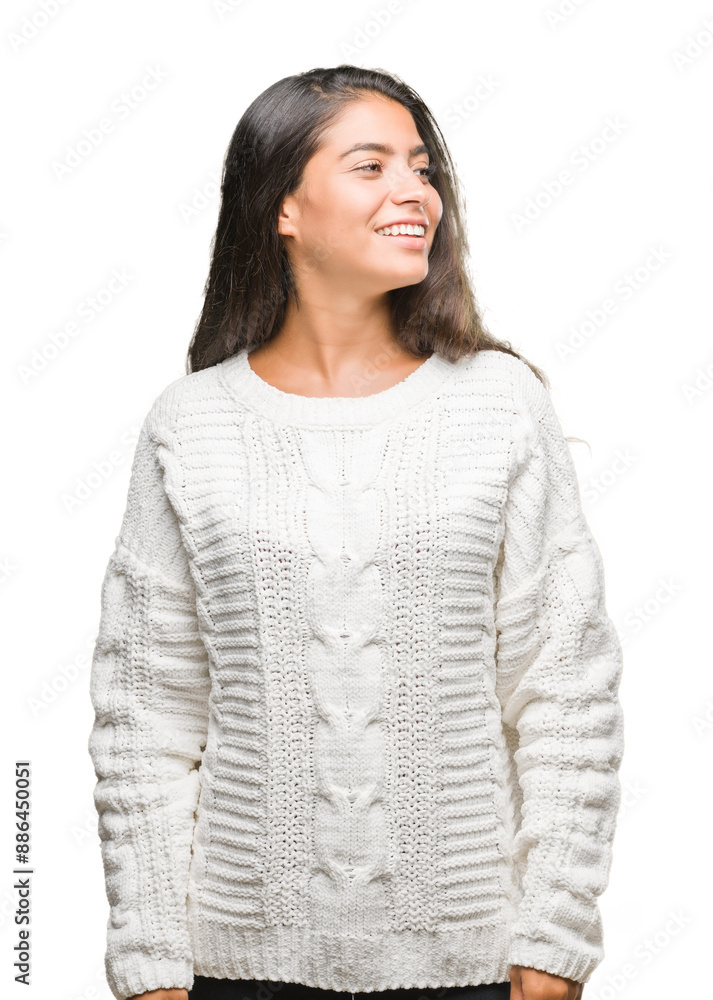 Wall mural Young beautiful arab woman wearing winter sweater over isolated background looking away to side with smile on face, natural expression. Laughing confident.