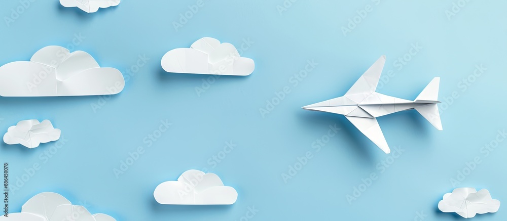 Aufkleber top view of white paper origami airplane on pastel blue background with clouds suitable for copy spa