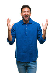Fototapeta premium Adult hispanic man over isolated background celebrating crazy and amazed for success with arms raised and open eyes screaming excited. Winner concept