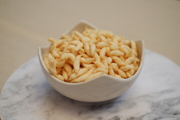 telur gabus sticks in white bowl on wooden table background.