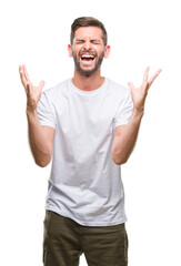 Young handsome man over isolated background celebrating mad and crazy for success with arms raised and closed eyes screaming excited. Winner concept