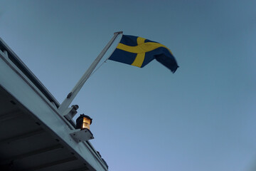 Low angle view of flag waving against clear sky