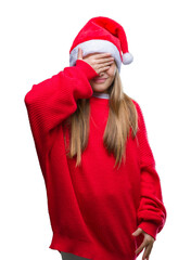 Young beautiful girl wearing christmas hat over isolated background smiling and laughing with hand...