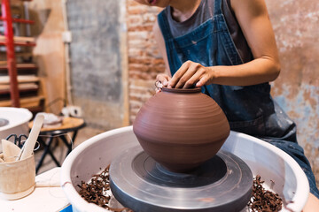 Hands, woman and painting ceramics for creativity, art workshop or class with hobby, paintbrush and material. Handmade, craft and pottery lesson with watercolor for clay bowl, design and recreation