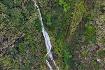 Cascading waterfall in green mountains of Madeira island, Aerial footage