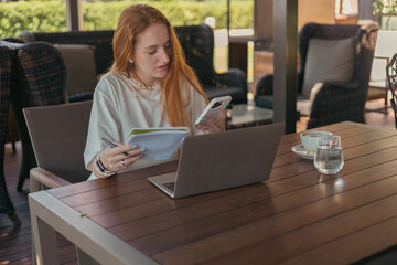 woman in cafe working or studying