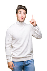 Naklejka premium Young handsome man wearing turtleneck sweater over isolated background pointing finger up with successful idea. Exited and happy. Number one.
