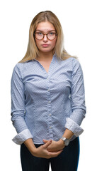 Young caucasian business woman wearing glasses over isolated background with serious expression on face. Simple and natural looking at the camera.