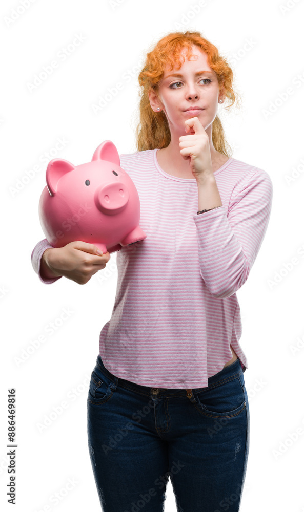 Sticker young redhead woman holding piggy bank serious face thinking about question, very confused idea