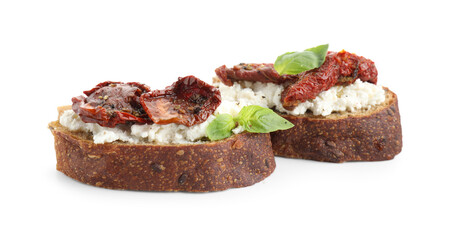 Delicious ricotta bruschettas with sun dried tomatoes and basil isolated on white