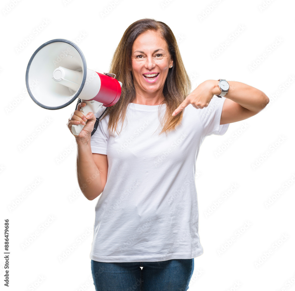 Wall mural middle age hispanic woman yelling through megaphone over isolated background with surprise face poin