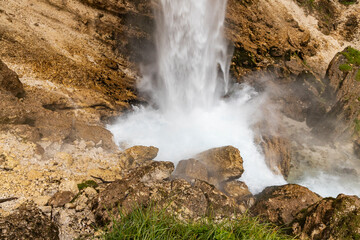 Perichnik waterfall is a beautiful drop from the mountain cliff, in Triglav National Park. Slovenian waterfall. Long for walking and trekking, enter inside the cave to admire it. Power and majesty.